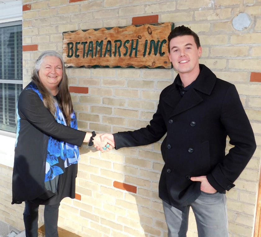 New Executive Director, Blake Muxlow shaking hands with Betty Bidwell